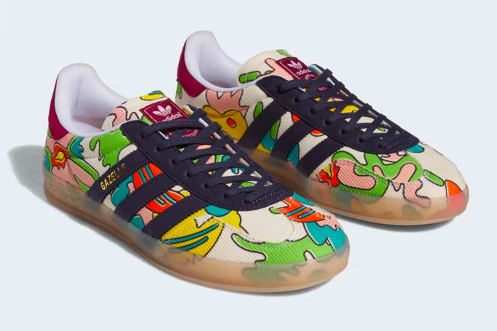 Side view of navy and green adidas sneakers.